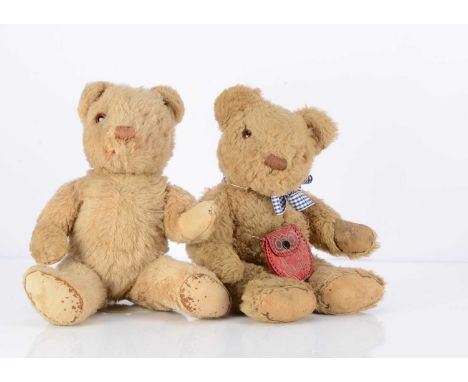 Two Invicta teddy bears, including a light brown wool plush, with chipped orange and black plastic eye, brown stitched nose a