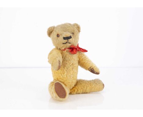 A 1930's Chad Valley Magna type teddy bear, with golden mohair, orange and black glass eyes, black  horizontal stitched nose,