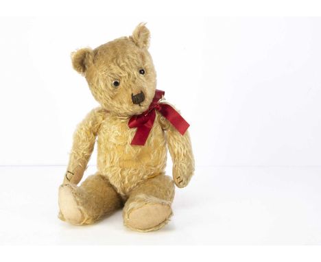 A 1930's Chiltern type teddy bear,  with blonde mohair, clear and black glass eyes, black stitched nose, mouth and claws, swi