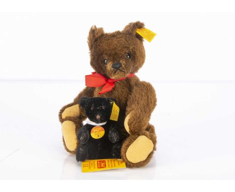 Two small Steiff yellow tag teddy bears,  comprising of a brown original teddy bear-- 9in. (23cm.) high; and a smaller black 