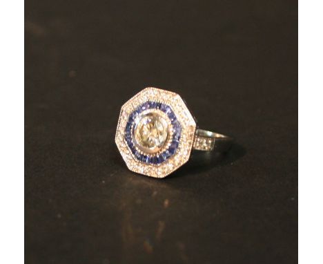 A 14ct. White Gold Sapphire and Diamond Cluster Ring, with a central diamond surrounded by a tier of sapphires and a tier of 