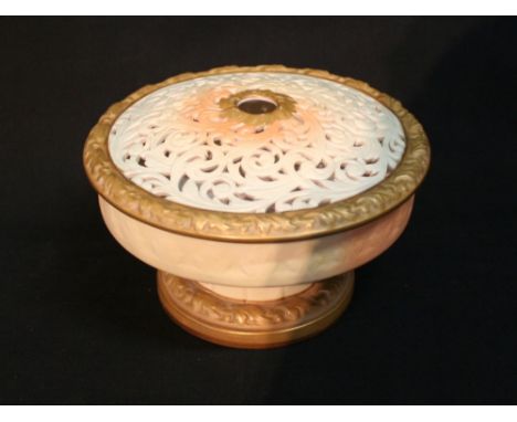 A Royal Worcester Porcelain Blush Ivory Pot Pourri, with a pierced scroll cover upon a circular stepped base, 17cms diameter