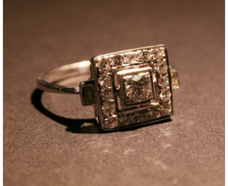 An 18ct. White Gold Art Deco Style Diamond Cluster Ring of Square Form, with baguette diamond shoulders