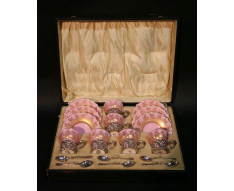 A Set of Six Royal Worcester Porcelain Coffee Cups and Saucers with gilt decoration upon a pink ground, the coffee cans all w