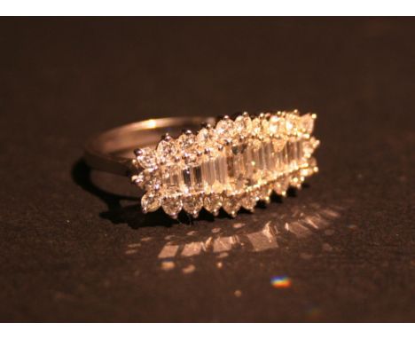 An 18ct White Gold Large Diamond Cluster Ring set with a row of baguette diamonds surrounded by diamonds within a pierced set