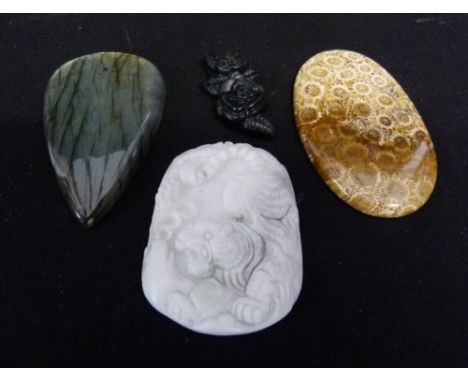 A Chinese White Jade Pendant decorated in relief with a tiger, together with three other similar pendants
