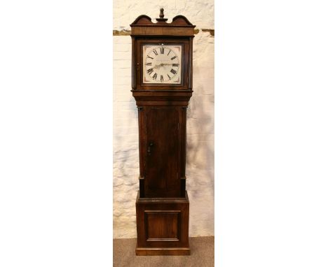 An Oak Longcase Clock, the square hood with turned pilasters above a shaped door and conforming plinth base, the painted dial