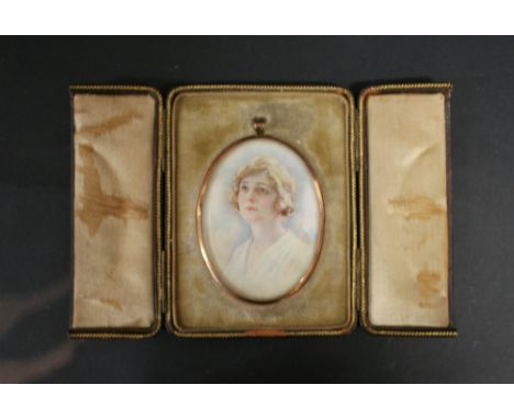 A 9ct. Gold Framed Oval Portrait Miniature within a fitted lined leather case