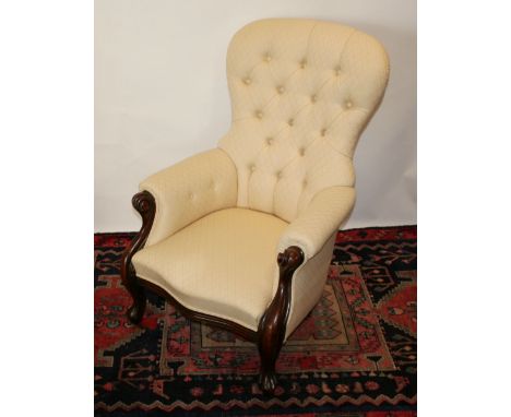 A Victorian Mahogany Drawing Room Armchair, with a button upholstered back above a padded seat with scroll arms raised upon c