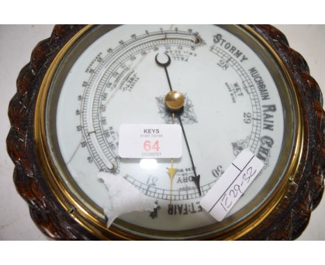 EARLY 20TH CENTURY ANEROID BAROMETER SET IN AN OAK ROPE FORMED CASE