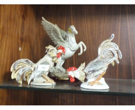 A PAIR OF CERAMIC COCK FIGHTER FIGURES TOGETHER WITH A PEGASUS ORNAMENT