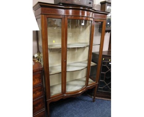 AN EDWARDIAN BOW FRONTED DISPLAY CABINET