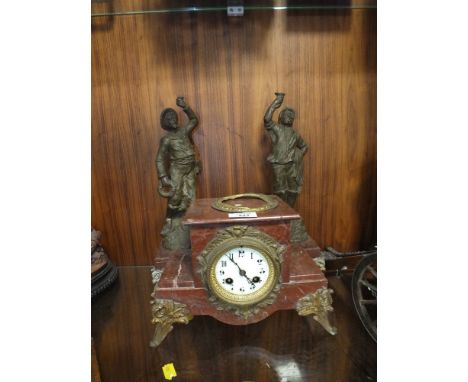A RED MARBLE MANTLE CLOCK WITH SPELTER STYLE FIGURATIVE GARNITURES  