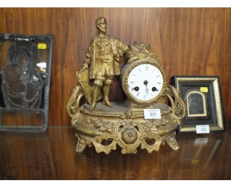 A FIGURATIVE GILT METAL MANTLE CLOCK 