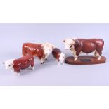 A Beswick matt glaze model of a Hereford bull, on wooden base, 7" high, a smaller Beswick Hereford