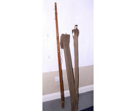 A Hardy Pope two-section fishing rod, in wooden case, and two other old fishing rods, in bags