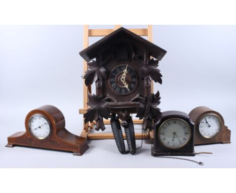 A Black Forest cuckoo clock, a French mahogany mantel clock with eight-day movement, a similar oak mantel clock and a Smith C
