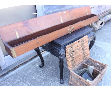 An early 20th century mahogany fishing rod box, containing fishing rods, gaff, etc, and a wicker fishing basket with contents