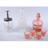 A tangerine glass decanter, four tots, a glass cocktail mixer jug with plated top and a clear