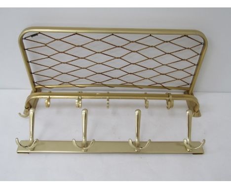 A brass coloured metal coat rack with string work shelf and another metal coat hanger 