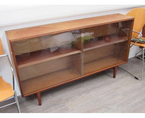 A teak glass fronted book shelf, 137cm x 28cm x 77.5cm 