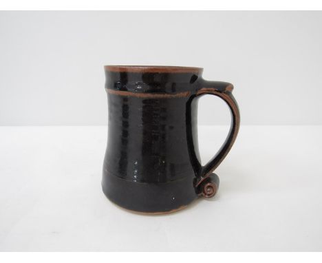 A Leach pottery tenmoku glazed tankard circa 1953.  St Ives seal.  12 cm high  