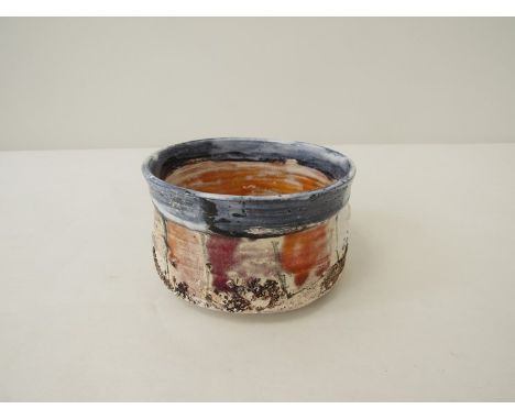 ROBIN WELCH (b.1936) A studio pottery chawan bowl with flashes of coloured glazes and slate blue glazed rim. Impressed seal. 