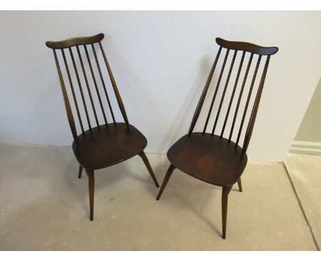 A pair of Ercol dark stained high stick back dining chairs 