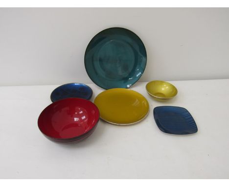 A small collection of enamel wares on tin and copper, dishes including Catherine Holm and one marked KM. Largest 21cm diamete