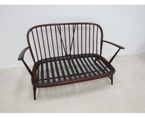 An Ercol dark stained two seater sofa - no cushions  