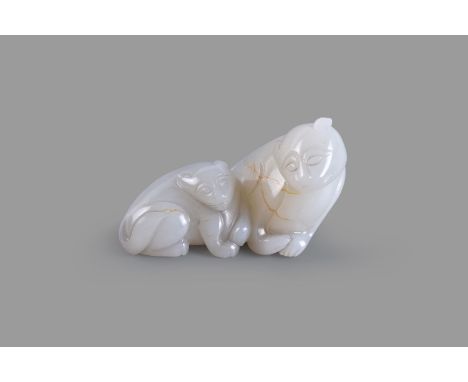 A white and russet jade 'Lion and Cub' pendant, carved seated on its haunches and its head facing to the right, with a cub ly