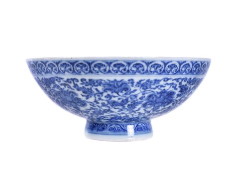 A Chinese blue and white bowl, the exterior decorated in  with a composite floral scroll, and the slightly flared foot encirc