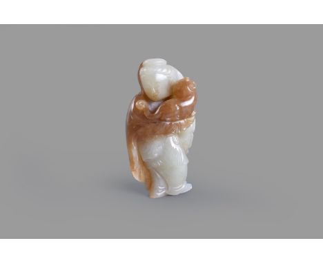 A Chinese celadon and russet jade 'Lady and cat' carving, carved as a lady holding a cat in her arms, 8.2cm high   青白玉巧色人物