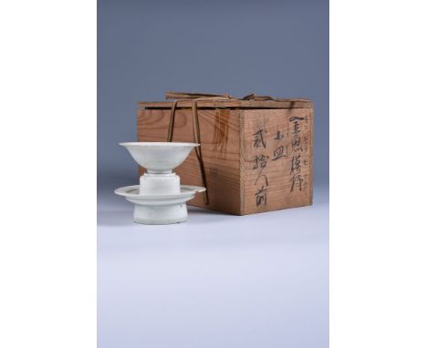 A Chinese Qingbai cup and stand, Song Dynasty (1127-1279), the thinly potted cup with narrow ribs rising to the slightly peta