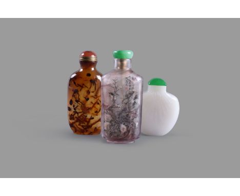A Chinese agate snuff bottle and stopper, with flecked inclusions, 8cm high overall; a white jade shell-shaped snuff bottle a