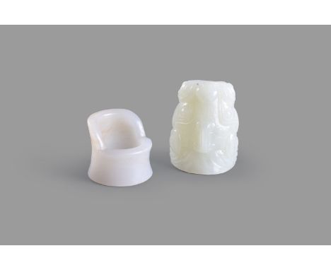 A Chinese white and russet jade archer's ring, 3.2cm high and a Chinese pale celadon mythical beast head archer's ring, 5cm l