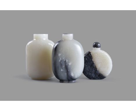 A group of three Chinese jade snuff bottles, including one unadorned white jade snuff bottle, 6.8cm high; one inscribed white
