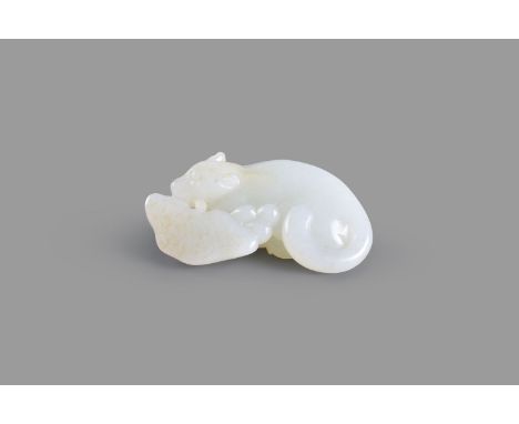 A white jade and russet 'squirrel and fungus' group, carved and pierced as a bushy tailed squirrel holding a branch of lingzh