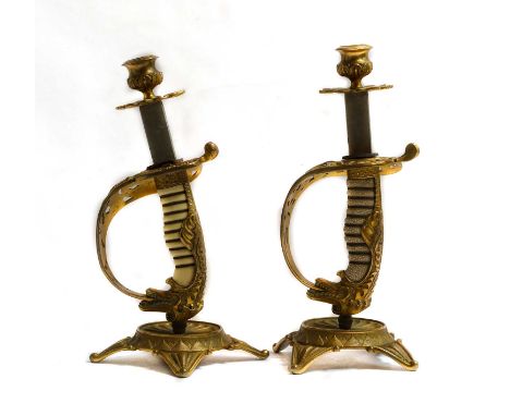 A pair of bronze sword hilt candlesticks of spurious pattern (2)