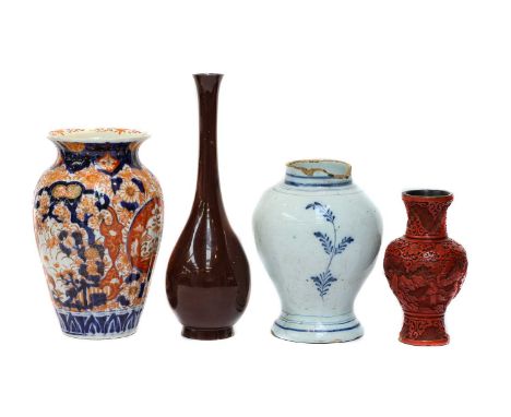 An 18th century Delft vase, a Chinese cinnabar lacquer vase, Tibetan prayer wheel, Kangxi marked saucer dish, three pieces of