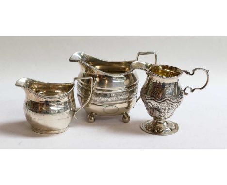 Three George III Silver Cream-Jugs, each London, 1771, one 1809 and one 1811, the first baluster and on spreading foot, the s
