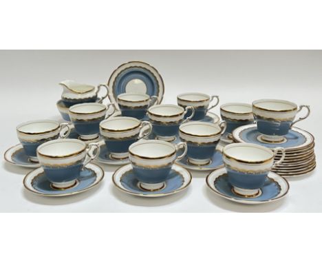 A Paragon China blue and gilt part tea set comprising twelve cups and ten saucers, a slop bowl/sugar basin, a milk jug (h- 11