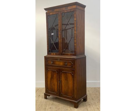 A Georgian style mahogany secretaire bookcase, the dentil cornice over two astragal glazed doors enlcosing two shelves, above