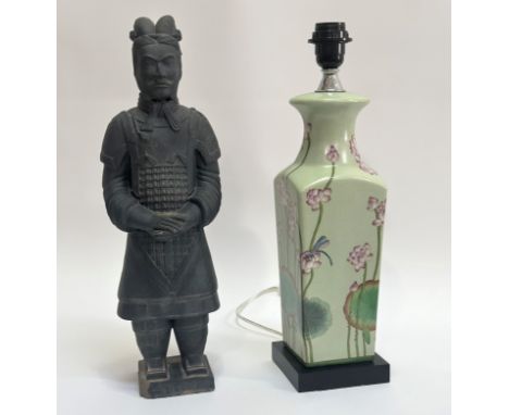 A Terracottta model Chinese warrior, in the period style (chip to base) (h- 46cm) and a ceramic table lamp decorated with a c