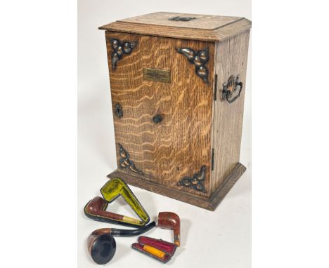 An Edwardian oak Art and Crafts presentation smokers cabinet the top with copper shield and copper carry handles to side, the