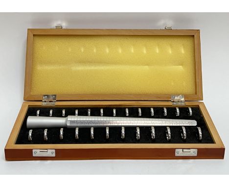 A boxed ring sizer/stick, marked with sizes for UK/USA/France, with twenty five finger gauges