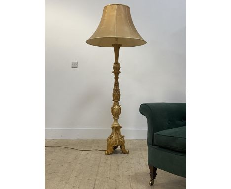 A late 20th century gilt composition standard lamp in the Rococo taste in the form of a candlestick, moulded with scrolling a