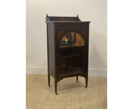 An Edwardian rosewood sheet music cabinet, the ledge back, top, case and glazed and mirrored door with boxwood stringing and 