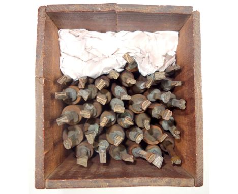Wooden box containing 36 gold finishing hand tools comprising complete alphabet, numbers 1-8, ampersand, and AE, (possibly 26