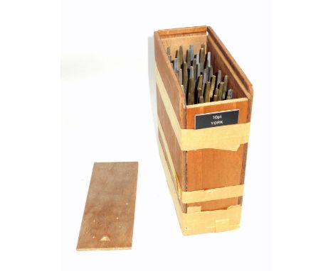 Wooden box containing 40 gold finishing hand tools comprising complete alphabet, numbers 0-9, ampersand, AE, OE, comma and po